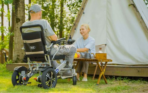 Man driving electric wheelchair for outdoor dining