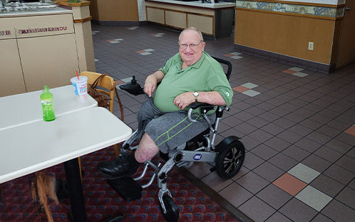 Wayne Shook with the V53 wheelchair at the restaurant.