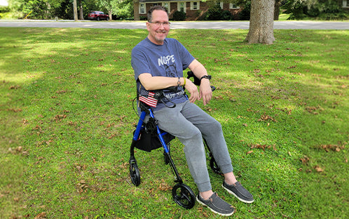 ALS patient Omar Dix is sitting on the Z21 Rollator Walker