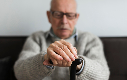 Elderly Parkinson's man resting on couch
