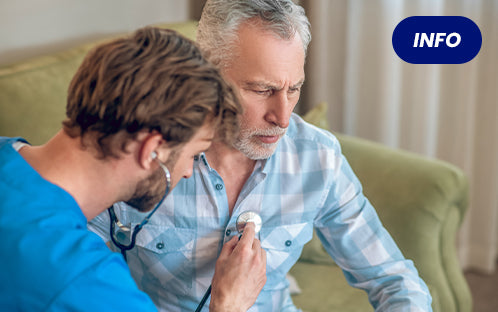caregiver is testing the heart rate of the elderly.
