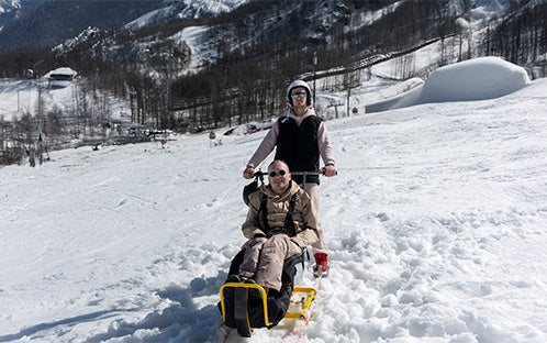 Man is using outdoor snow mobility lift 