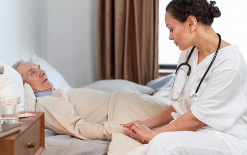 Caregiver taking care of seniors lying in bed