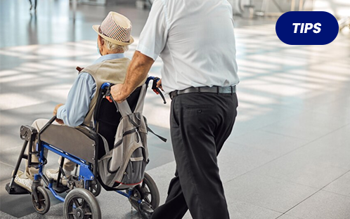 Seniors travel with a wheelchair in the airport.