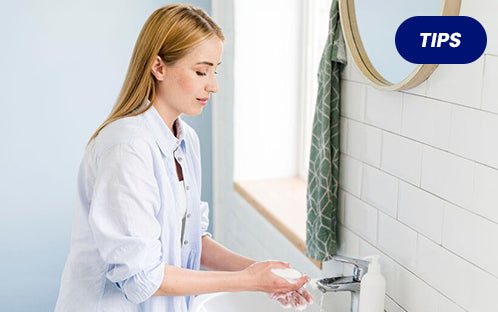A caregiver washes her hands
