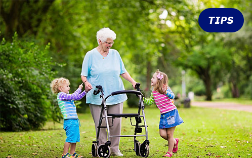 A senior with a rollator walker with a seat at park