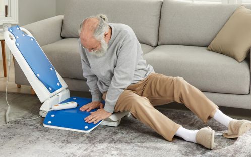 Elderly man gets up with electric lift chair
